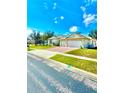 Lovely single-story home featuring a lush lawn, brick driveway, and a convenient two-car garage at 5525 Thorngrove Way, Spring Hill, FL 34609