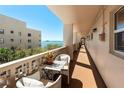 Balcony furnished with seating and a table, offering serene waterfront views and privacy at 620 Edgewater Dr # 501, Dunedin, FL 34698