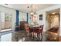 Charming dining area features elegant décor, marble floors, and an eye-catching hanging light fixture at 620 Edgewater Dr # 501, Dunedin, FL 34698