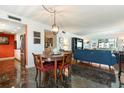 Dining room with marble floors, a hanging light fixture, and plenty of room to gather around the table at 620 Edgewater Dr # 501, Dunedin, FL 34698
