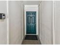 Welcoming entryway featuring a blue door and textured walls at 6343 92Nd N Pl # 2102, Pinellas Park, FL 33782