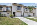 Townhome featuring balconies, a one car garage, a front lawn and neutral siding at 6343 92Nd N Pl # 2102, Pinellas Park, FL 33782