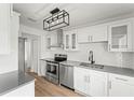 Bright kitchen with stainless steel appliances, white cabinets, and modern lighting at 6505 Julie St, Tampa, FL 33610