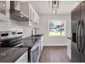 Well-lit kitchen with stainless steel appliances, granite countertops and subway tile backsplash at 6505 Julie St, Tampa, FL 33610