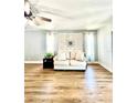 Bright living room featuring hardwood floors and a decorative wall at 717 Cordova Green, Seminole, FL 33777