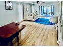 Comfortable living area with a plush sofa, wood floors, and access to a patio with seating at 717 Cordova Green, Seminole, FL 33777