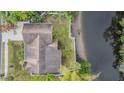 Aerial view of the property highlighting the spacious lot, landscaping, and proximity to water at 8425 Jackson Springs Rd, Tampa, FL 33615