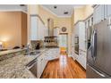 Modern kitchen featuring granite countertops, stainless steel appliances, and ample cabinet space for storage at 8425 Jackson Springs Rd, Tampa, FL 33615