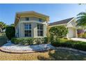 Charming home featuring a bay window, lush landscaping, and stone accents, creating a welcoming curb appeal at 1038 Emerald Dunes Dr, Sun City Center, FL 33573