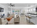 Bright, open-concept living room with access to the pool and a modern kitchen at 1044 Manzanar Pl, Wesley Chapel, FL 33543