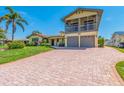 Charming two-story home with an attached two-car garage and brick driveway surrounded by mature landscaping at 1140 81St S St, St Petersburg, FL 33707