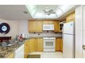 The kitchen features modern white appliances, ample cabinet storage, and granite countertops at 12924 Gulf Blvd # 310, Madeira Beach, FL 33708