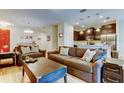Comfortable living room featuring stylish sofas, decorative pillows, and an open layout leading to the kitchen at 13217 Canopy Creek Dr, Tampa, FL 33625