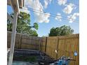 Fenced backyard showing a wooden fence and a corner for plants or a garden at 1329 Tuscola St, Clearwater, FL 33756