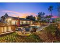 Inviting backyard featuring a pool, lounge chairs, deck, and lush greenery for serene outdoor living at 1330 Gulfview Woods Ln, Tarpon Springs, FL 34689