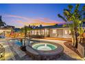 Relaxing backyard with a pool, hot tub, and outdoor kitchen with a covered deck for entertaining at 1330 Gulfview Woods Ln, Tarpon Springs, FL 34689