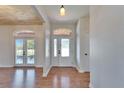 Inviting entryway with wood floors and a stylish front door with decorative glass at 14807 Capps Estates Ln, Wimauma, FL 33598