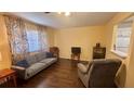 Inviting living room featuring hardwood floors, cozy seating, and natural light from the window at 1801 Bedford Ln # 46, Sun City Center, FL 33573