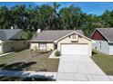 Charming one-story home with a well-manicured lawn and a two-car garage at 2033 Shadow Pine Dr, Brandon, FL 33511