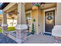 Inviting front porch showcasing decorative hanging plants and a stylish, welcoming entrance at 21832 Crest Meadow Dr, Land O Lakes, FL 34637