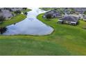 Beautiful aerial view of homes surrounding a lake in a lush golf course community at 2401 Richmond Greens Ct, Sun City Center, FL 33573
