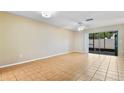Spacious living room featuring tile floors and sliding glass doors that provide natural light and backyard access at 2930 S Pines Dr # 109, Largo, FL 33771