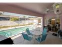Inviting covered patio with a ceiling fan overlooking the screened-in pool area, perfect for outdoor dining at 3051 Jodi Ln, Palm Harbor, FL 34684