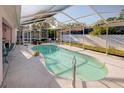 Enjoy this refreshing screened-in pool, perfect for relaxation and fun in the sun at 3051 Jodi Ln, Palm Harbor, FL 34684