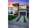 Striking modern home boasts clean lines, large windows, a two-car garage, and lush landscaping at 3105 S Schiller St, Tampa, FL 33629