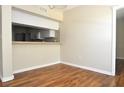 Open dining area next to the kitchen, featuring hardwood flooring and a breakfast bar at 3358 Mermoor Dr # 2106, Palm Harbor, FL 34685