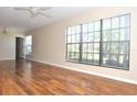 Bright living room featuring hardwood flooring and a large window providing ample natural light at 3358 Mermoor Dr # 2106, Palm Harbor, FL 34685