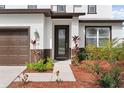 Inviting front entrance with glass inserted front door, manicured landscaping, and a well-maintained walkway at 5424 Hammock View Ln, Apollo Beach, FL 33572