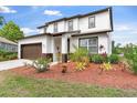 Beautiful two-story home with meticulous landscaping, a spacious driveway, and a charming, well-maintained lawn at 5424 Hammock View Ln, Apollo Beach, FL 33572