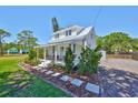 Beautiful home with a lush front yard and covered porch, offering curb appeal and charm at 609 4Th Sw Ave, Ruskin, FL 33570