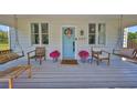 Cozy front porch with swing seating, perfect for relaxing and enjoying the outdoors at 609 4Th Sw Ave, Ruskin, FL 33570