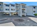View of the condo building featuring covered parking and staircase access to the upper levels at 803 Bahia Del Sol Dr # 66, Ruskin, FL 33570