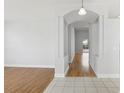 Bright hallway with hardwood flooring and neutral walls, leading to various rooms in the home at 8847 Bel Meadow Way, Trinity, FL 34655