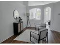 Bright and airy living room with modern furnishings, arched doorway, and wood-look flooring at 10275 Oasis Palm Dr, Tampa, FL 33615