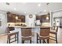 Open kitchen featuring granite countertops, dark wood cabinets, and stainless steel appliances at 11327 Emerald Shore Dr, Riverview, FL 33579