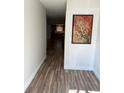 Hallway featuring wood-look floors and an art piece at 1200 Abbey Crescent Ln, Clearwater, FL 33759