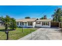 Inviting single-story home with a well-maintained lawn, mailbox, and convenient carport at 1209 W Camellia Dr, Brandon, FL 33510