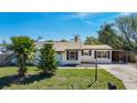 Charming single-story home with a well-manicured lawn, mature trees, and inviting curb appeal at 1209 W Camellia Dr, Brandon, FL 33510