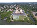 Stunning aerial view of waterfront condo complex with tennis court, ample parking, and lush greenery at 12760 Indian Rocks Rd # 579, Largo, FL 33774