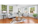 Bright living room with hardwood floors, white sofa, and plenty of natural light at 1617 Oak Ne St, St Petersburg, FL 33704