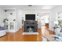 Cozy living room featuring a brick fireplace, built-in shelving, and hardwood floors at 1617 Oak Ne St, St Petersburg, FL 33704