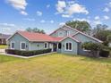 Beautiful single-story home with well-maintained landscaping and a vibrant red tile roof at 18502 Keystone Manor Rd, Odessa, FL 33556