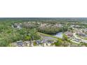 Scenic aerial view showcasing the community, lush green spaces, and a tranquil lake at 25029 Hyde Park Blvd, Land O Lakes, FL 34639