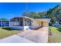 Inviting home showcasing a screened-in porch and a carport, offering comfortable outdoor living spaces at 34834 Carl Ave, Zephyrhills, FL 33541
