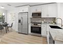Modern kitchen with stainless steel appliances, white cabinets, and breakfast nook at 4146 Brentwood Park Cir, Tampa, FL 33624