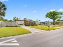 Well-maintained single-story home featuring a green lawn and inviting curb appeal at 4532 W Idlewild Ave, Tampa, FL 33614